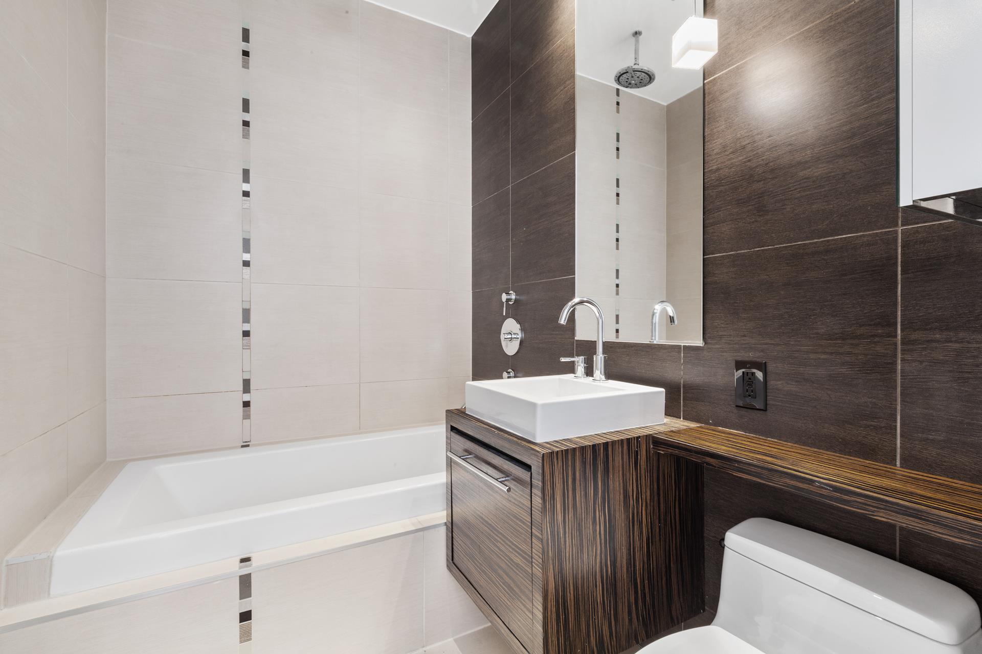 170 North 11th Street, Unit 3F Brooklyn, NY 11211 - Photo 8 of 9 a bathroom with a sink a toilet and shower