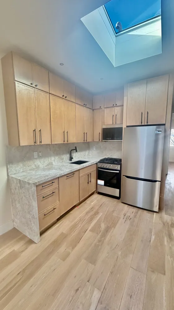 a kitchen with stainless steel appliances granite countertop a refrigerator sink and cabinets