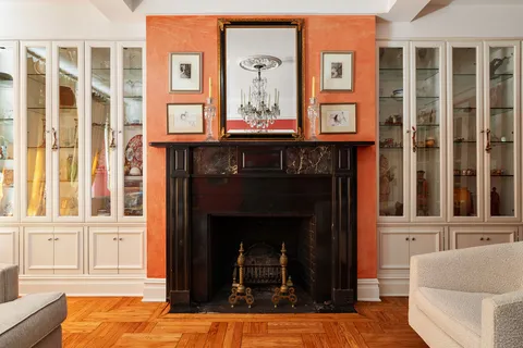 a living room with a fireplace and a window