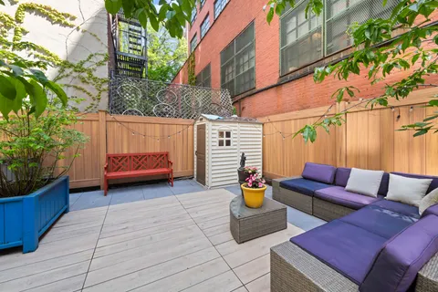a view of a patio with couches table and chairs and potted plants