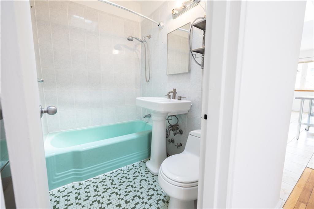 1506 Dahill Road Brooklyn, NY 11204 - Photo 11 of 13 a bathroom with a sink toilet and shower
