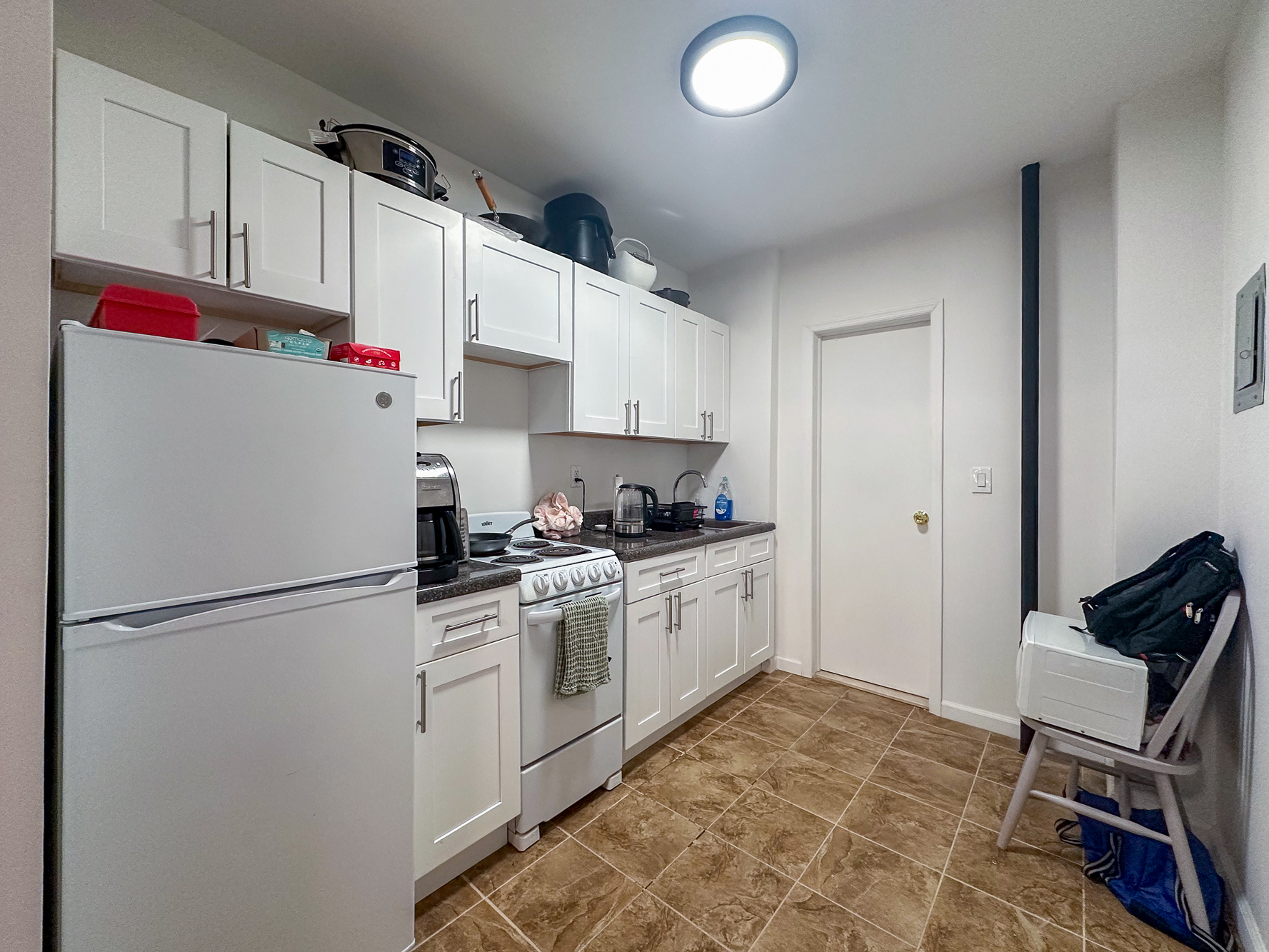 342 East 9th Street, Unit 3B Manhattan, NY 10003 - Photo 6 of 9 a kitchen with stainless steel appliances granite countertop a refrigerator sink stove and white cabinets