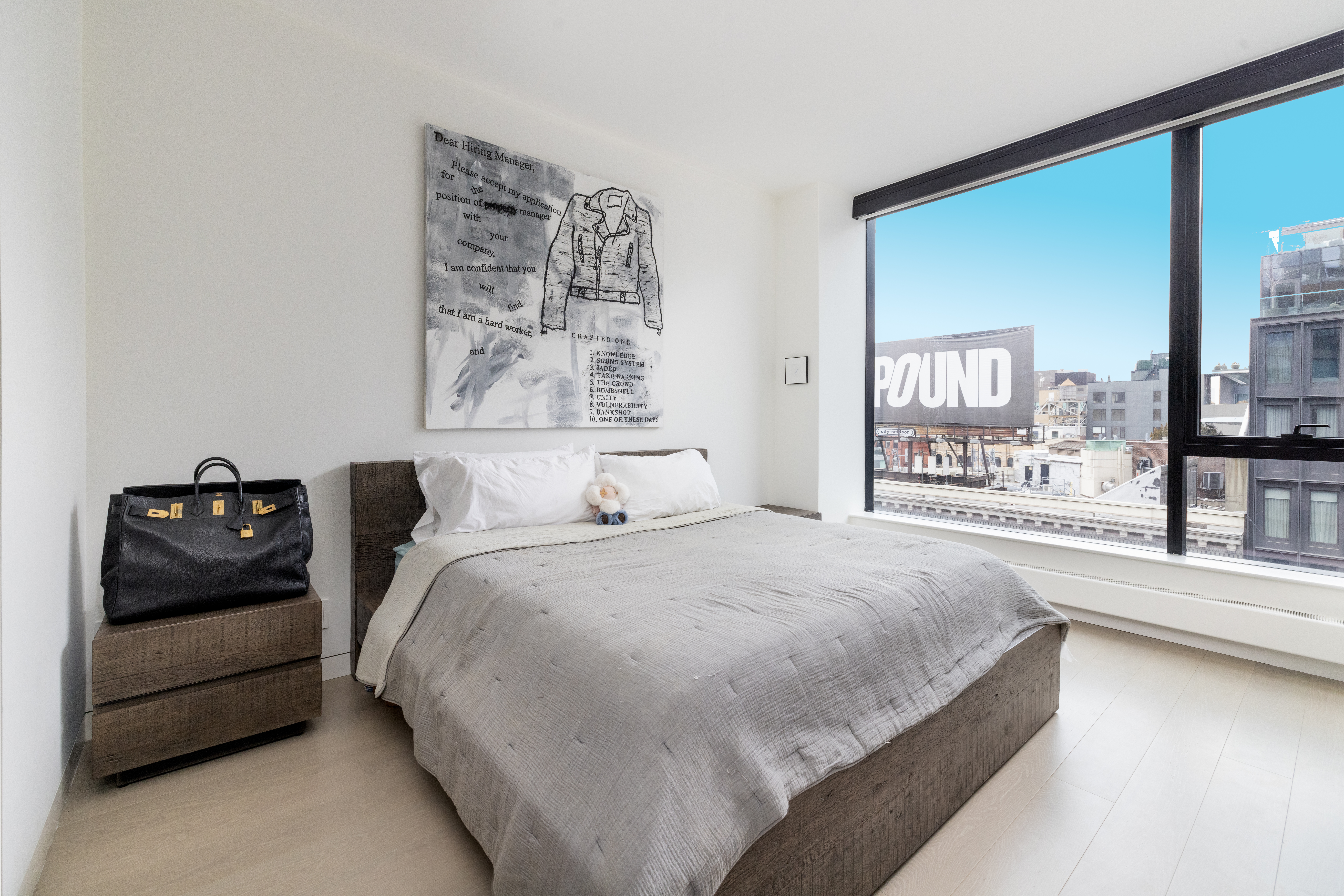 255 Hudson Street, Unit 9C Manhattan, NY 10013 - Photo 9 of 19 a bedroom with a bed and a large window with outer view