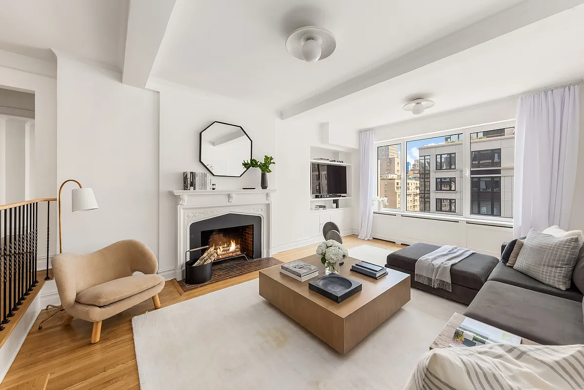 180 East 79th Street, Unit 14B Manhattan, NY 10075 - Photo 3 of 18 a living room with furniture a fireplace and window