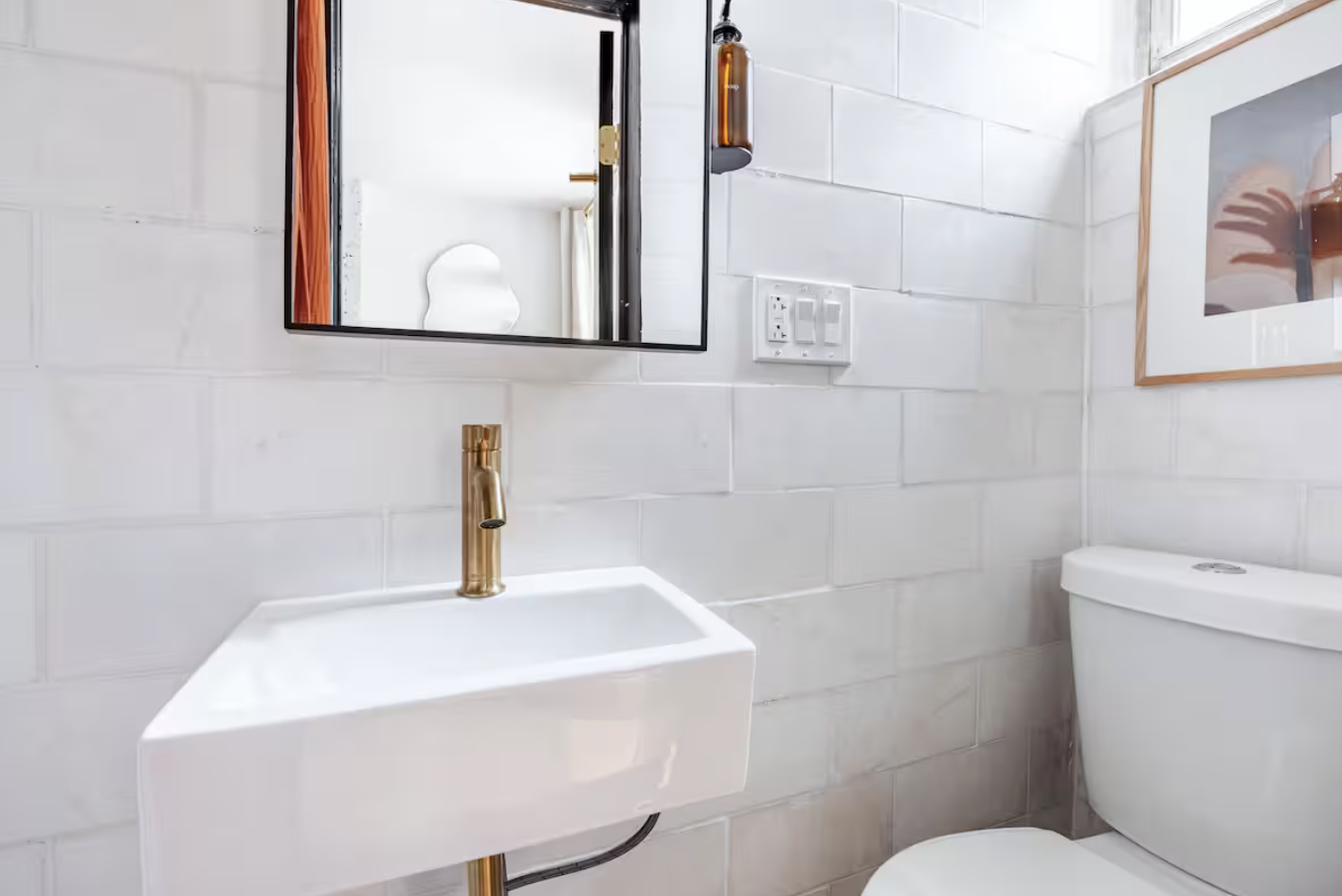 240 Mulberry Street, Unit 2 Manhattan, NY 10012 - Photo 16 of 19 a bathroom with a toilet sink and mirror