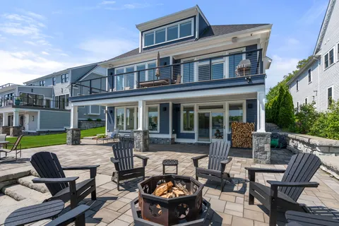 a view of a house with backyard and sitting area