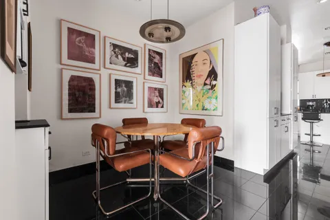 a dining room with furniture and window