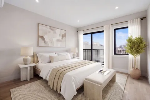 a bedroom with a bed and a potted plant