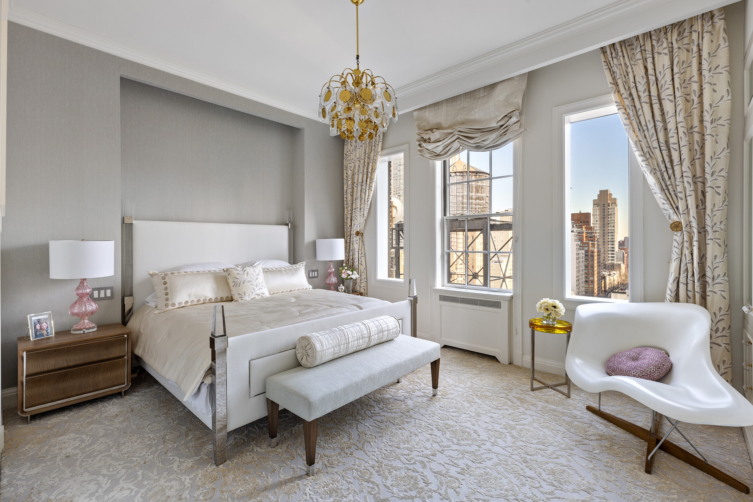 535 Park Avenue, Unit 14C Manhattan, NY 10065 - Photo 11 of 18 a spacious bedroom with a bed and a chandelier