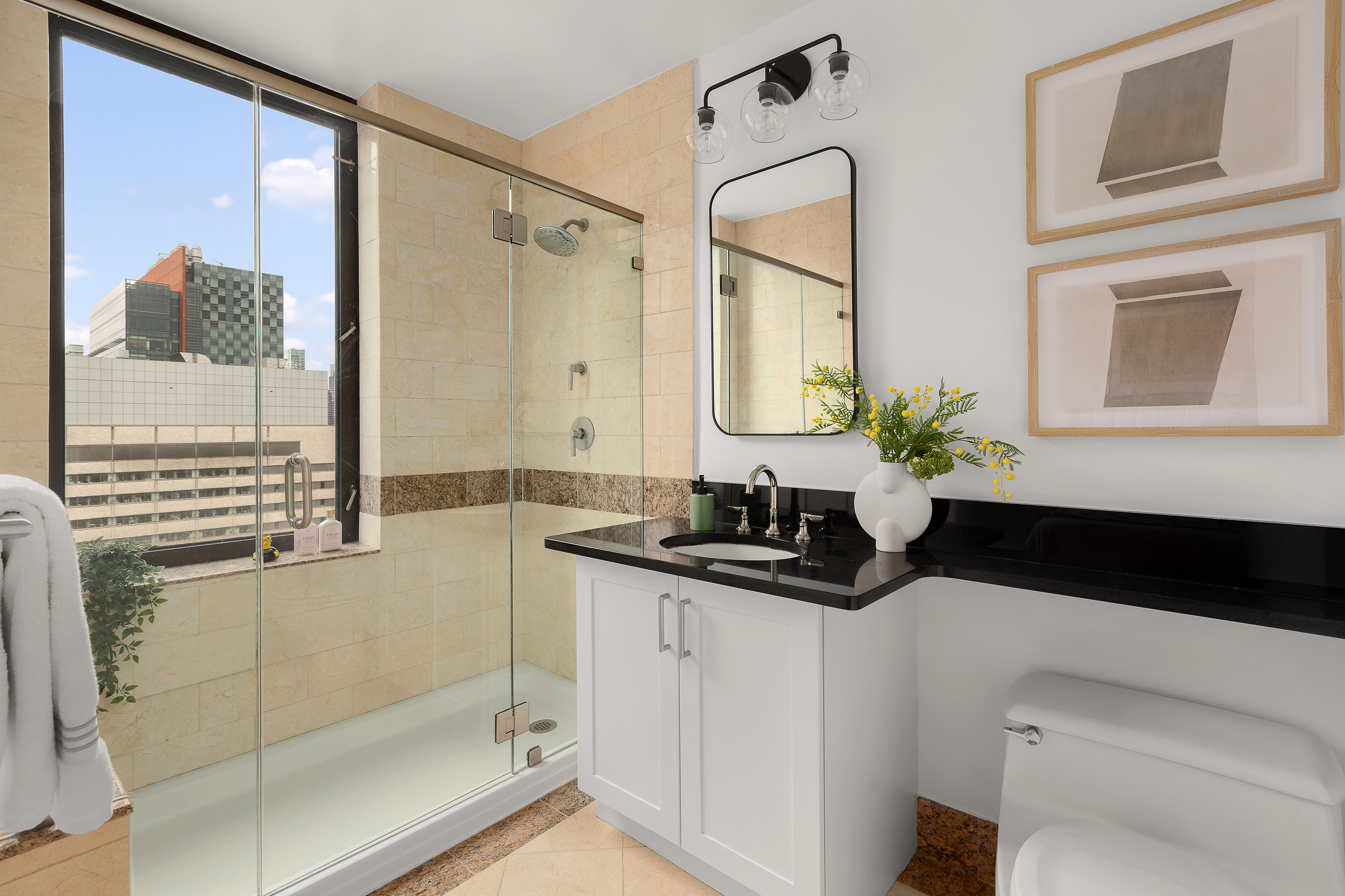 422 East 72nd Street, Unit 27C Manhattan, NY 10021 - Photo 20 of 25 a bathroom with a granite countertop sink a mirror and shower