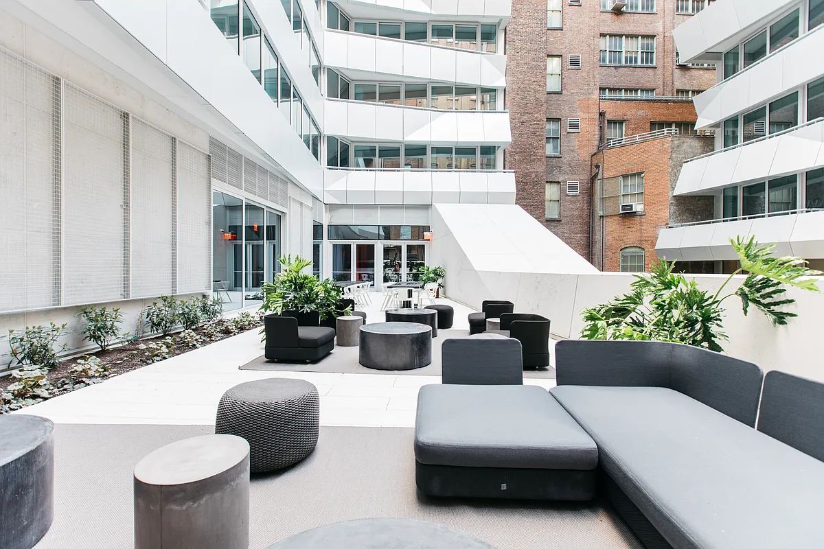 121 East 22nd Street, Unit N205 Manhattan, NY 10010 - Photo 7 of 17 a view of a patio with couches table and chairs and potted plants