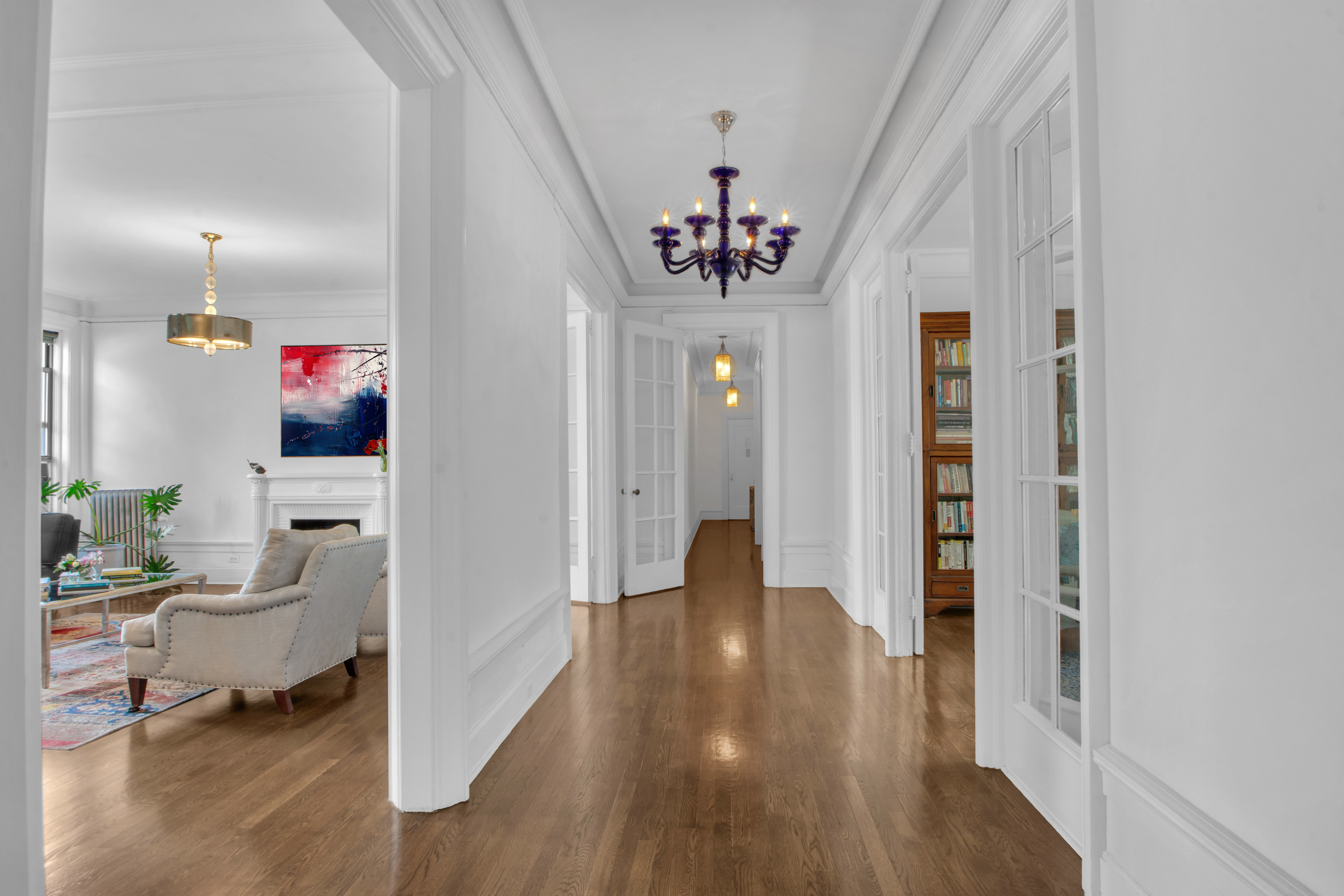 800 Riverside Drive, Unit 2E Manhattan, NY 10032 - Photo 5 of 27 a view of a hallway with wooden floor and a dining room