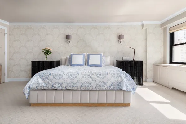 a bedroom with a bed dresser and a window