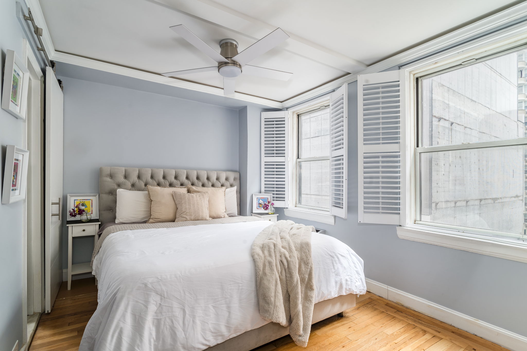 155 East 49th Street, Unit 10E Manhattan, NY 10017 - Photo 6 of 12 a bed sitting in a bedroom next to a window