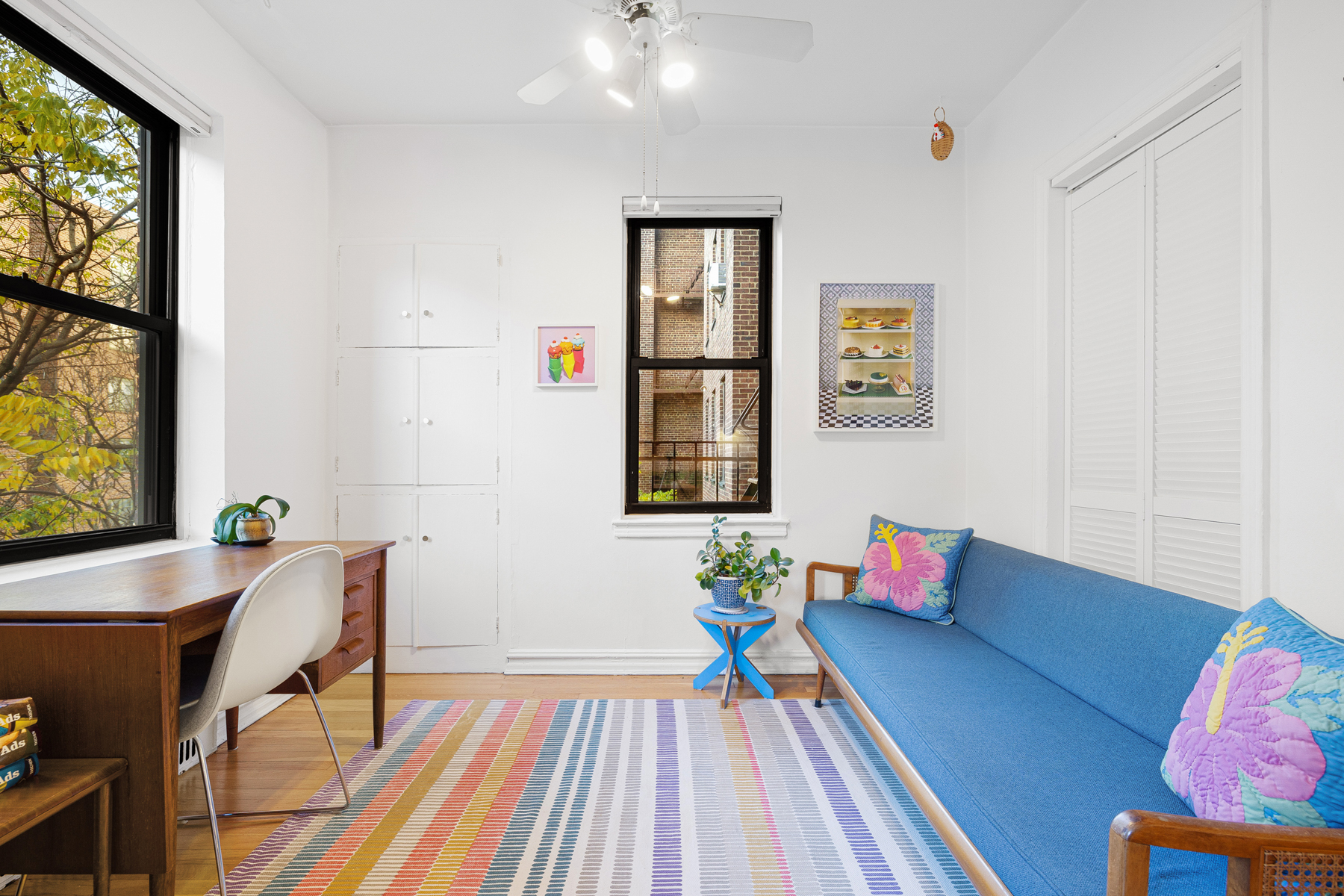 77-11 35th Avenue, Unit 3N Queens, NY 11372 - Photo 7 of 21 a living room with furniture and a window