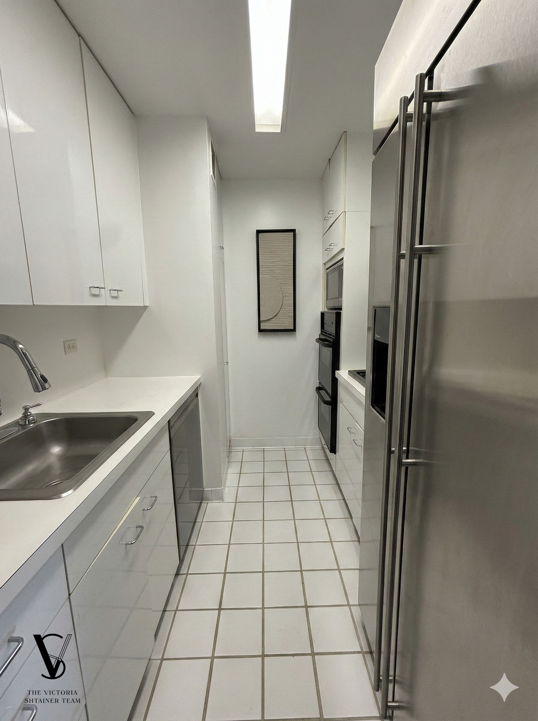 415 East 54th Street, Unit 6D Manhattan, NY 10022 - Photo 6 of 18 a kitchen with a refrigerator sink and cabinets