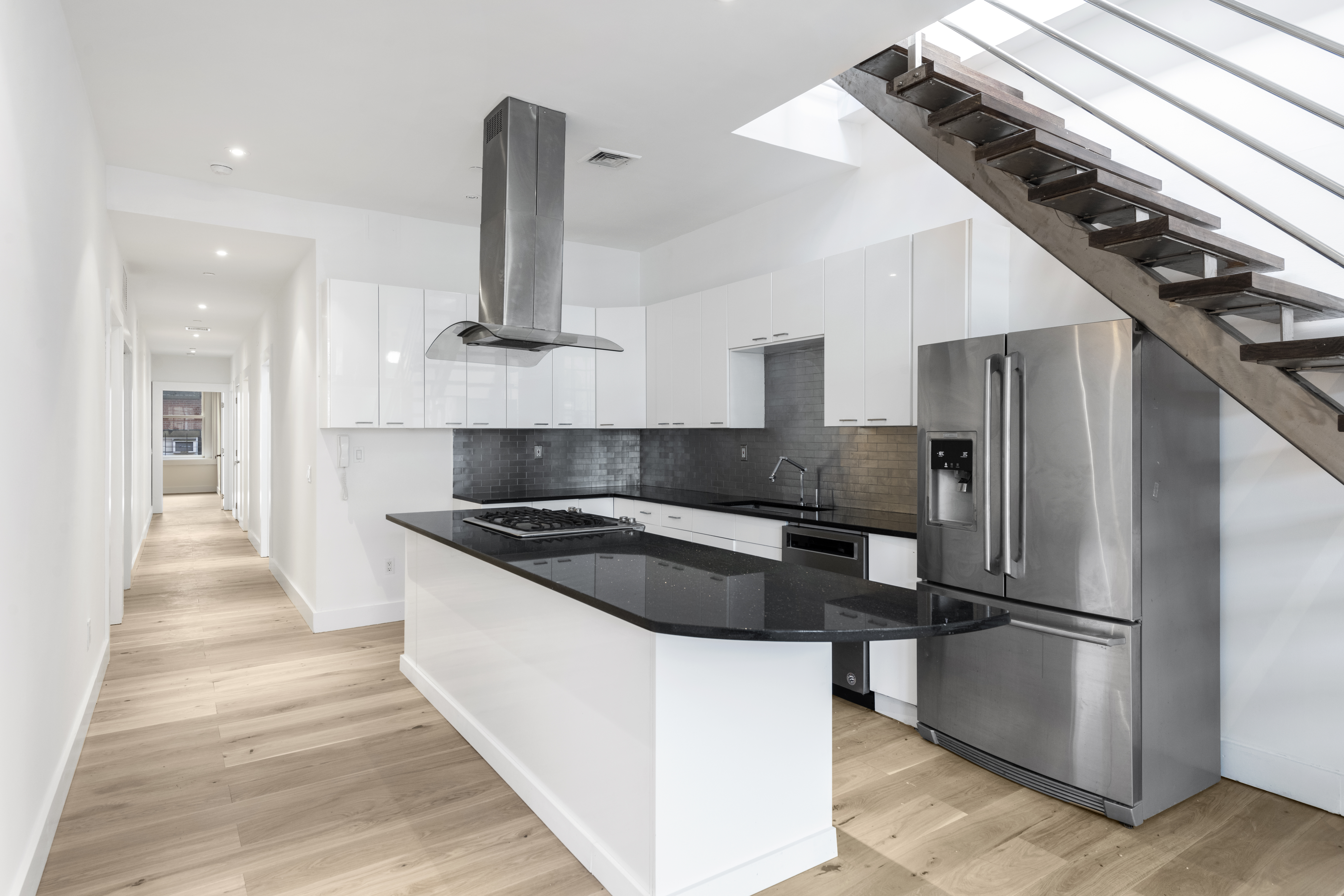49 Walker Street, Unit PH Manhattan, NY 10013 - Photo 3 of 14 a kitchen with granite countertop a refrigerator and a stove top oven