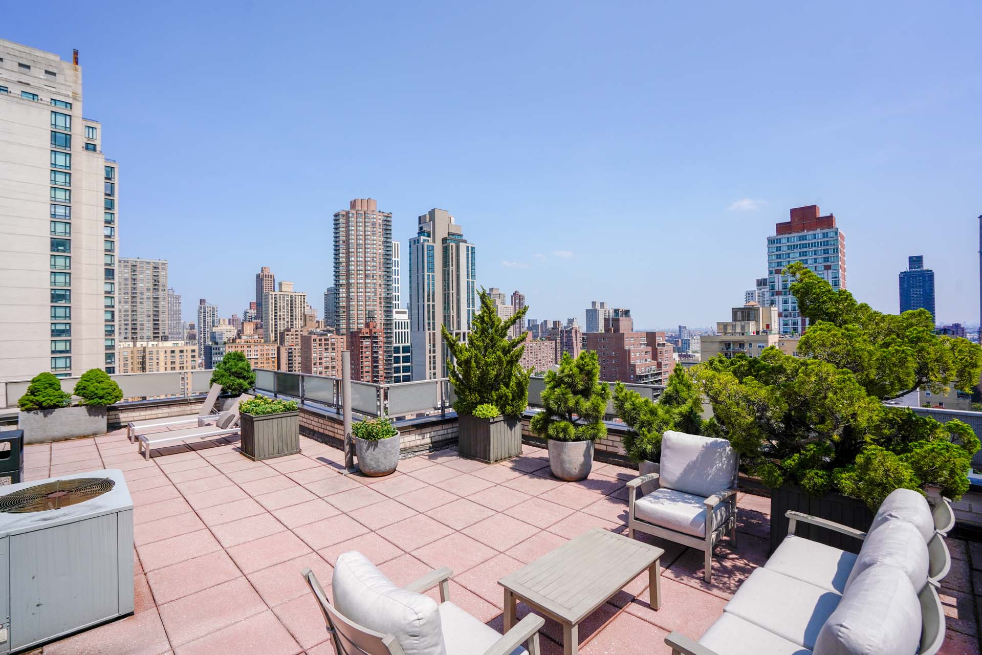 301 East 75th Street, Unit 2G Manhattan, NY 10021 - Photo 9 of 14 a view of a terrace with chairs potted plants and a bench