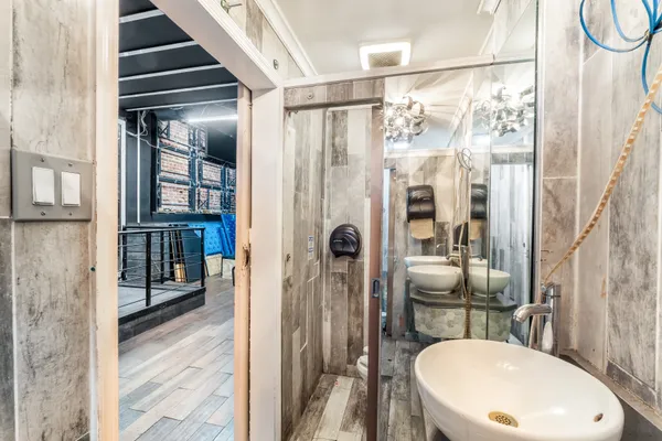a bathroom with a sink toilet and shower