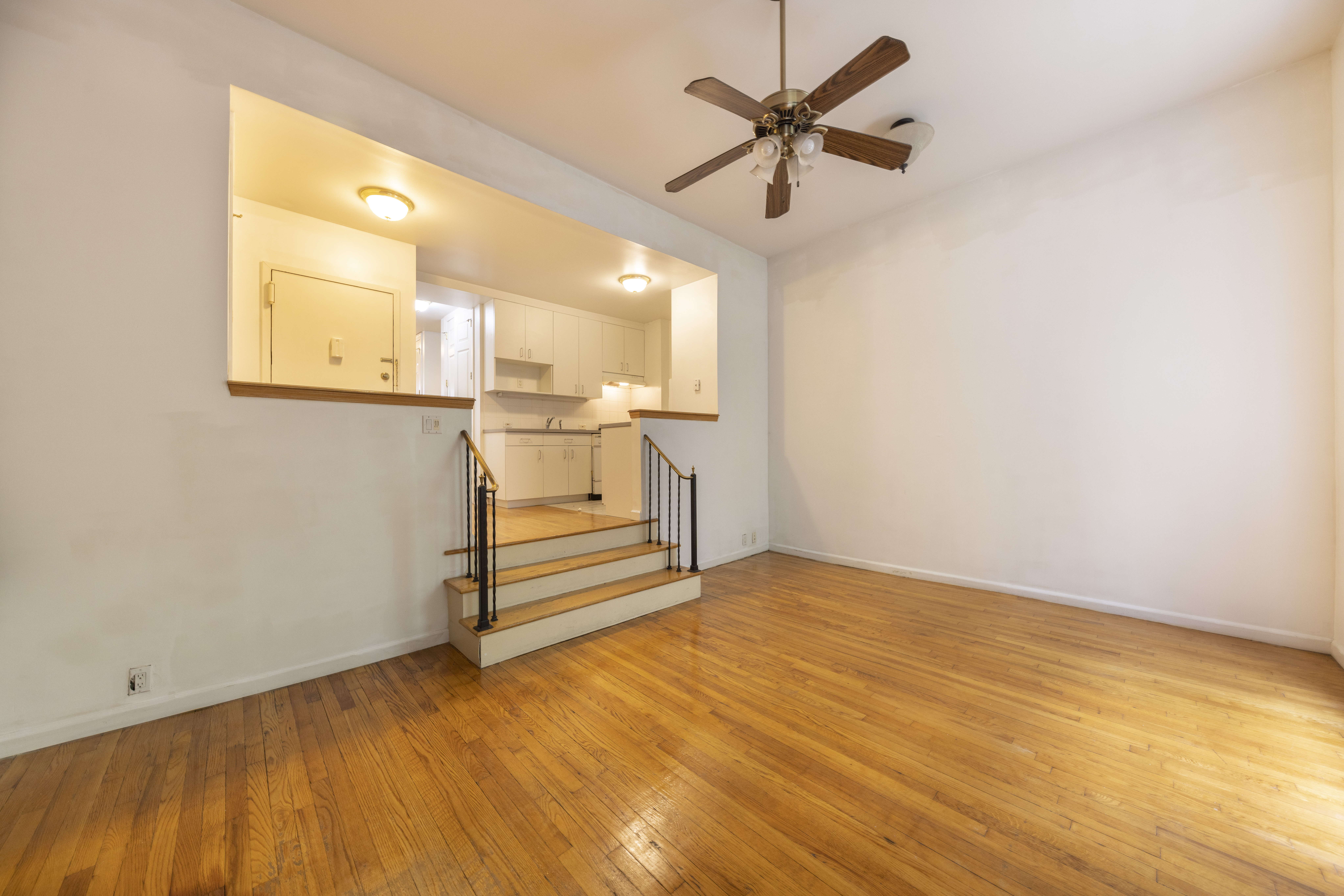 1384 Lexington Avenue, Unit 2 Manhattan, NY 10128 - Photo 2 of 11 a view of a livingroom with wooden floor and a ceiling fan