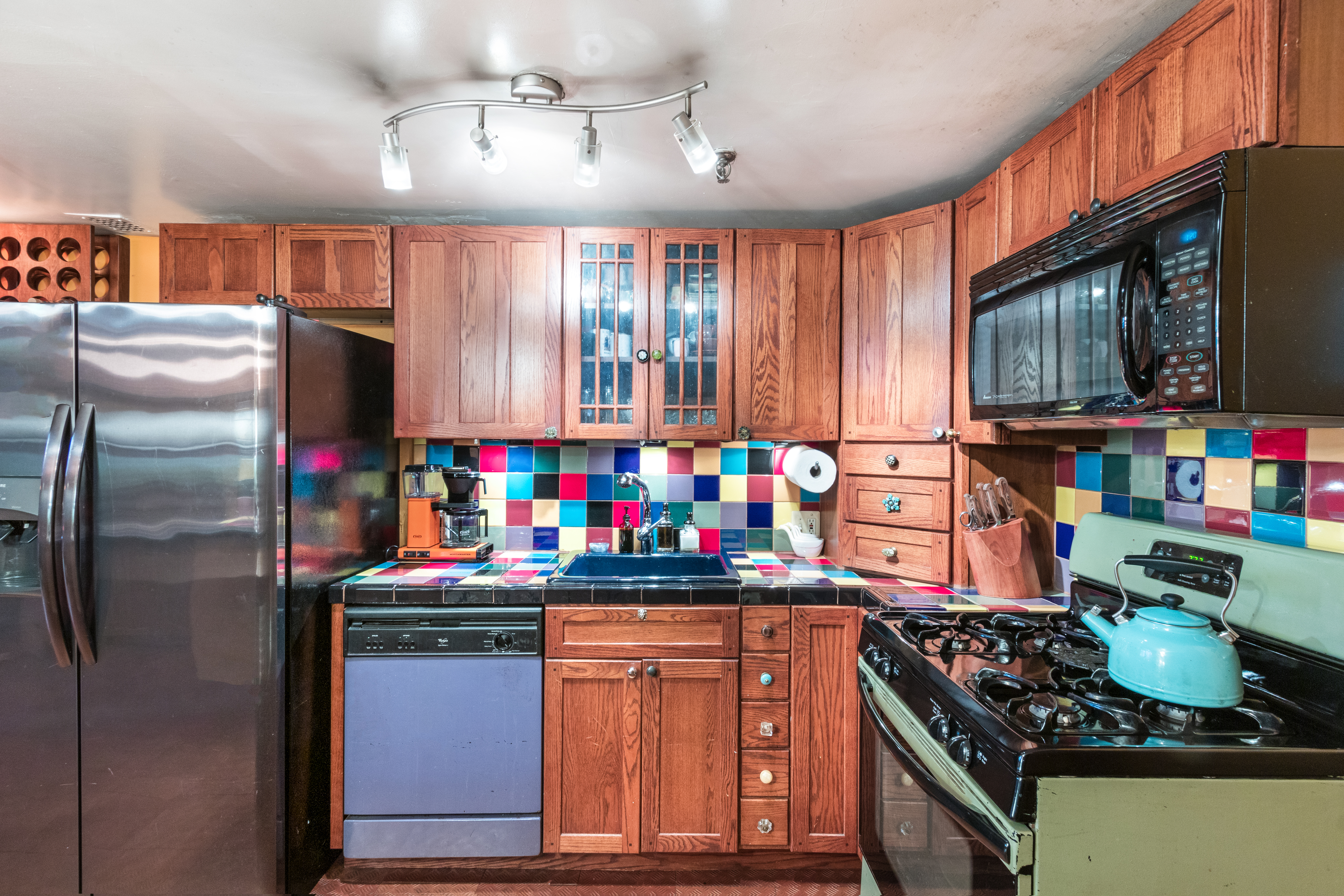 324 Pearl Street, Unit 1F Manhattan, NY 10038 - Photo 3 of 12 a kitchen with stainless steel appliances granite countertop a stove refrigerator and cabinets