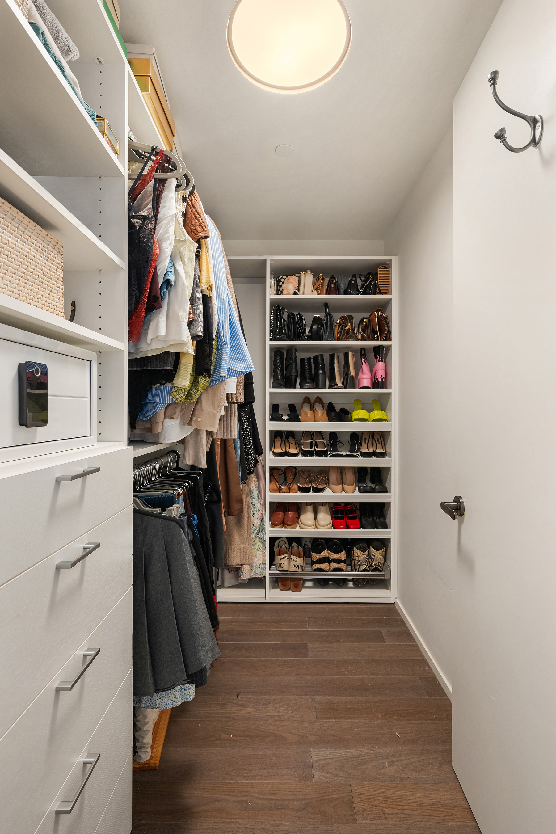 543 West 122nd Street, Unit 10E Manhattan, NY 10027 - Photo 10 of 12 a view of walk in closet with clothes and shoes