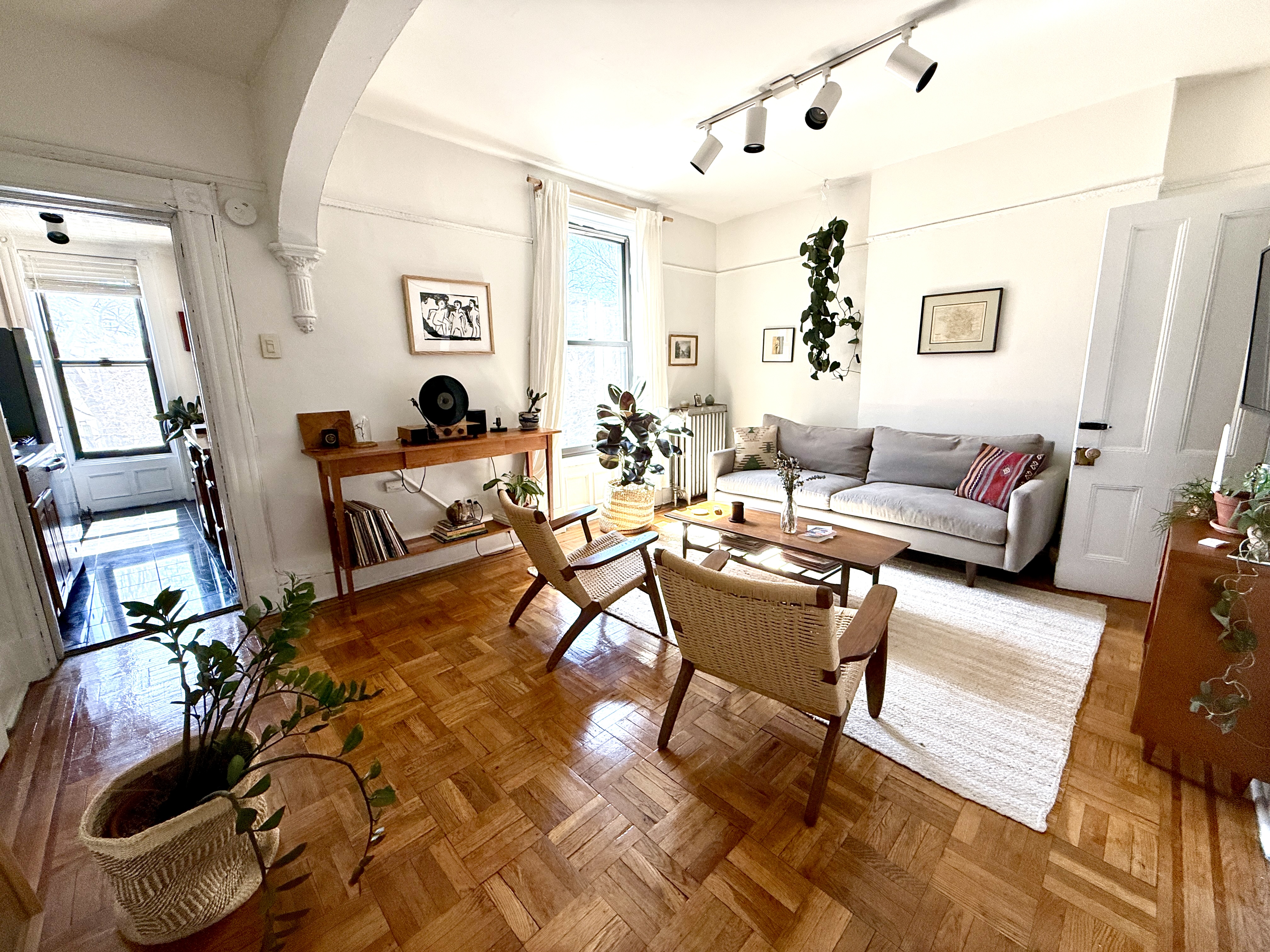 a living room with furniture and wooden floor