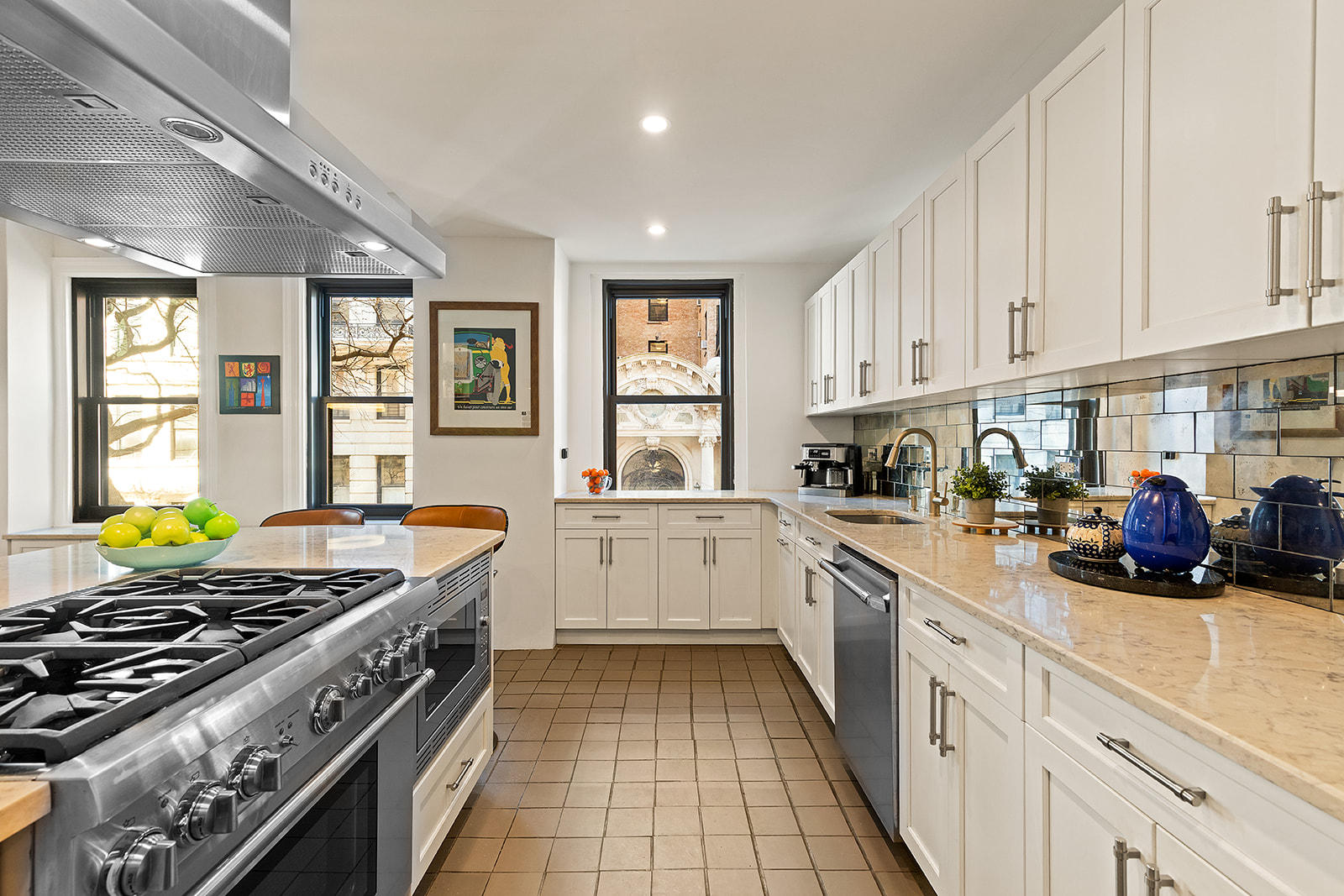 300 West 108th Street, Unit 2C Manhattan, NY 10025 - Photo 6 of 16 a kitchen with stainless steel appliances a stove a sink and white cabinets