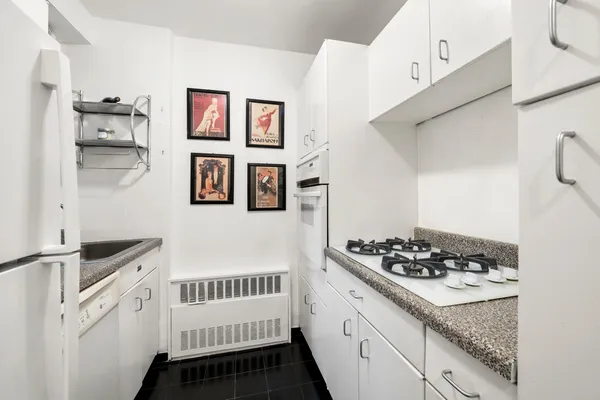 a kitchen with stainless steel appliances kitchen island a stove a refrigerator and cabinets