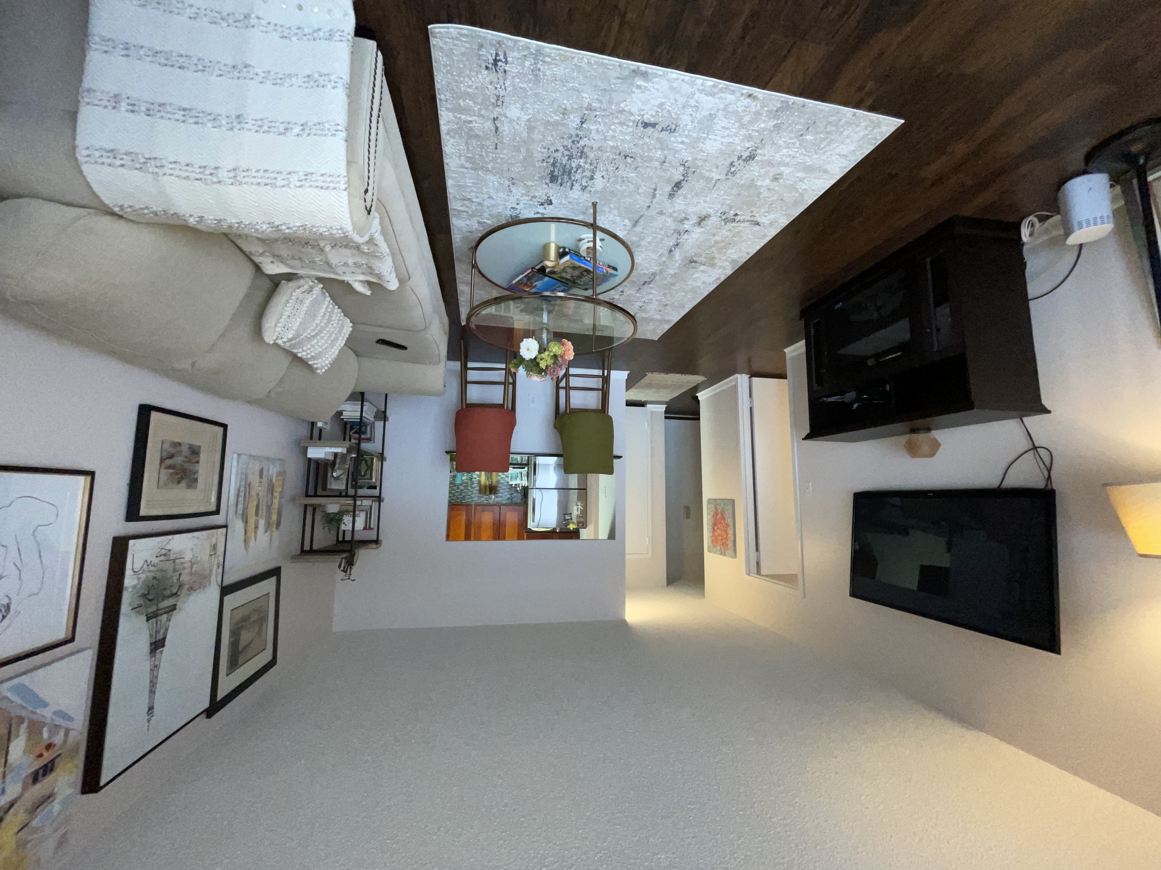 25-40 Shore Boulevard, Unit 8T Queens, NY 11102 - Photo 6 of 23 a living room with furniture a flat screen tv and a fireplace