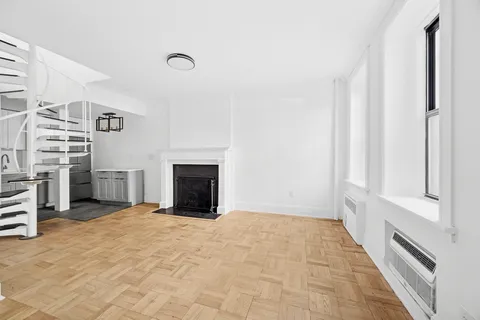 a view of an empty room with a fireplace