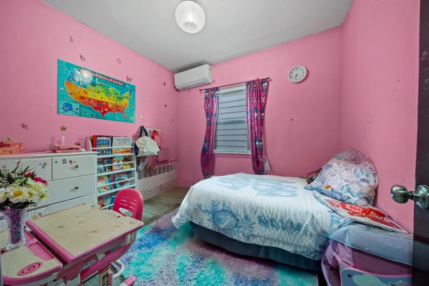 a bedroom with a bed and a dresser