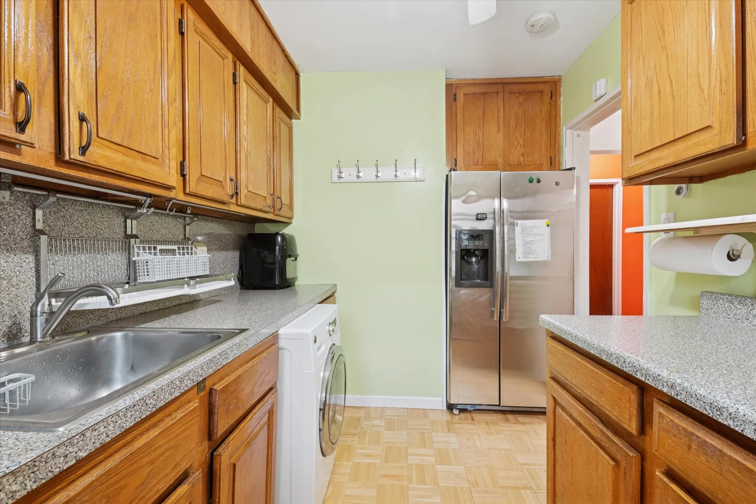 a kitchen with stainless steel appliances granite countertop a refrigerator and a sink
