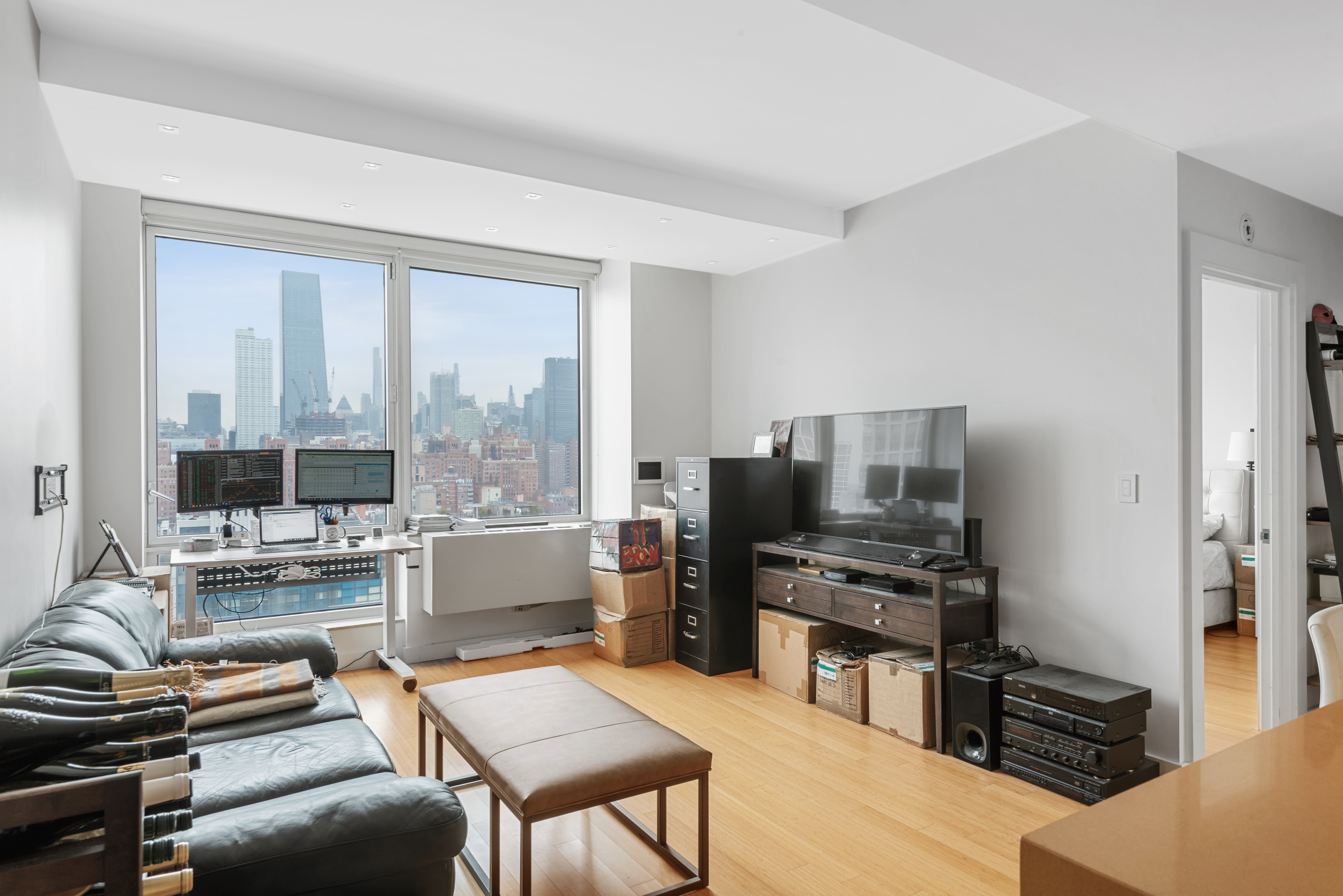 450 West 17th Street, Unit 1811 Manhattan, NY 10011 - Photo 1 of 14 a room with furniture and a flat screen tv