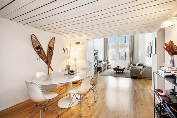 a dining room with furniture and wooden floor