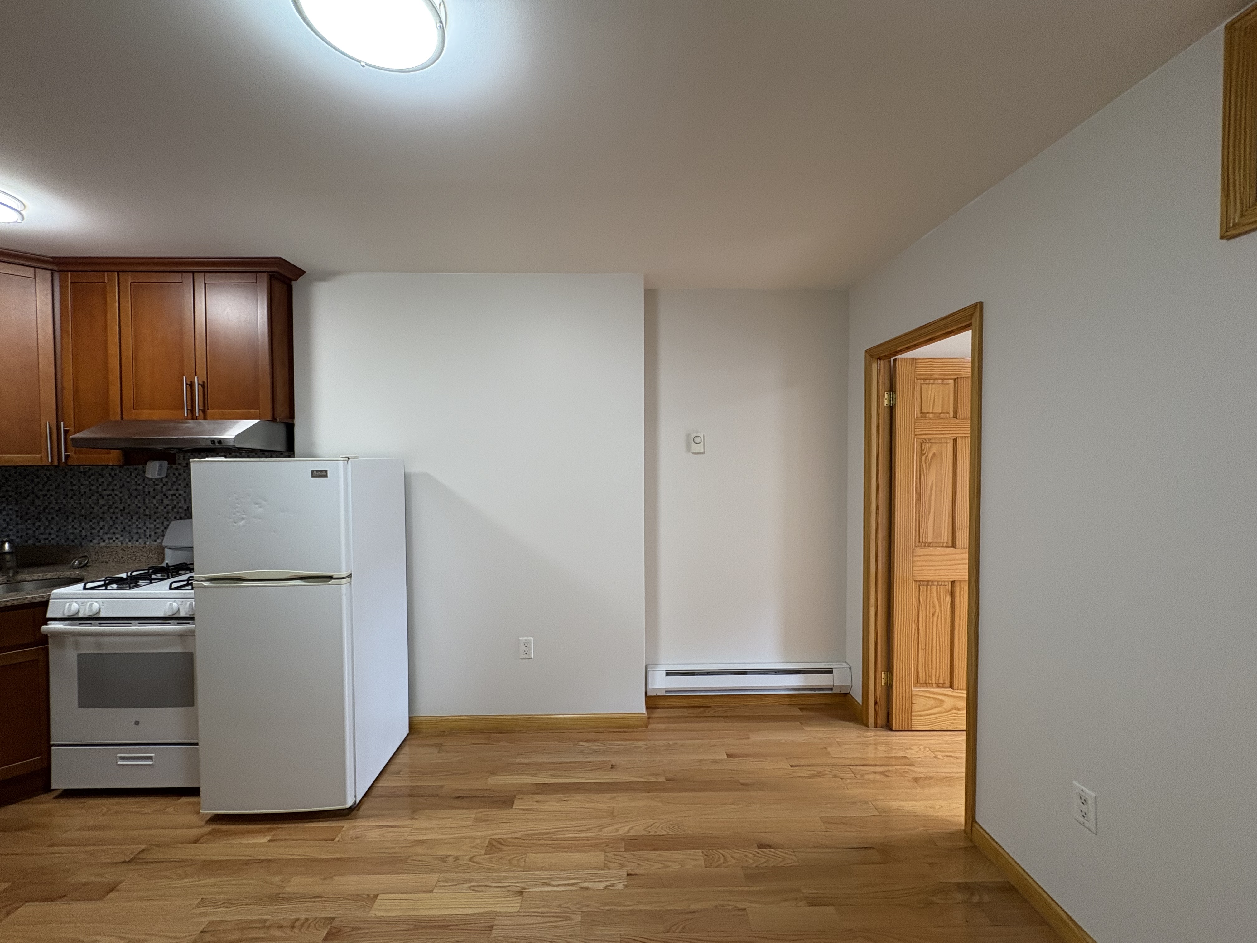 38 Ludlow Street, Unit 15 Manhattan, NY 10002 - Photo 9 of 16 a view of a kitchen with a sink dishwasher and a refrigerator