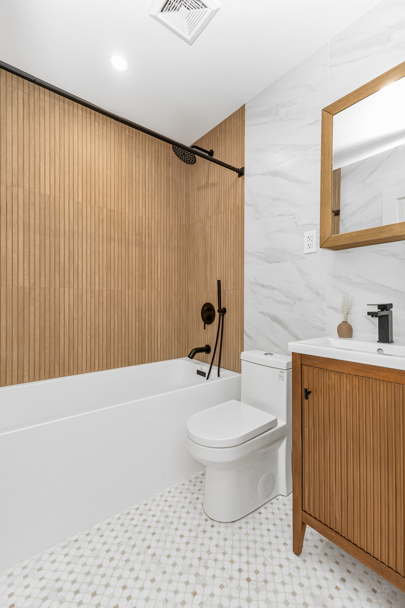 1050 Sterling Place Brooklyn, NY 11213 - Photo 11 of 23 a bathroom with a toilet a sink and a mirror