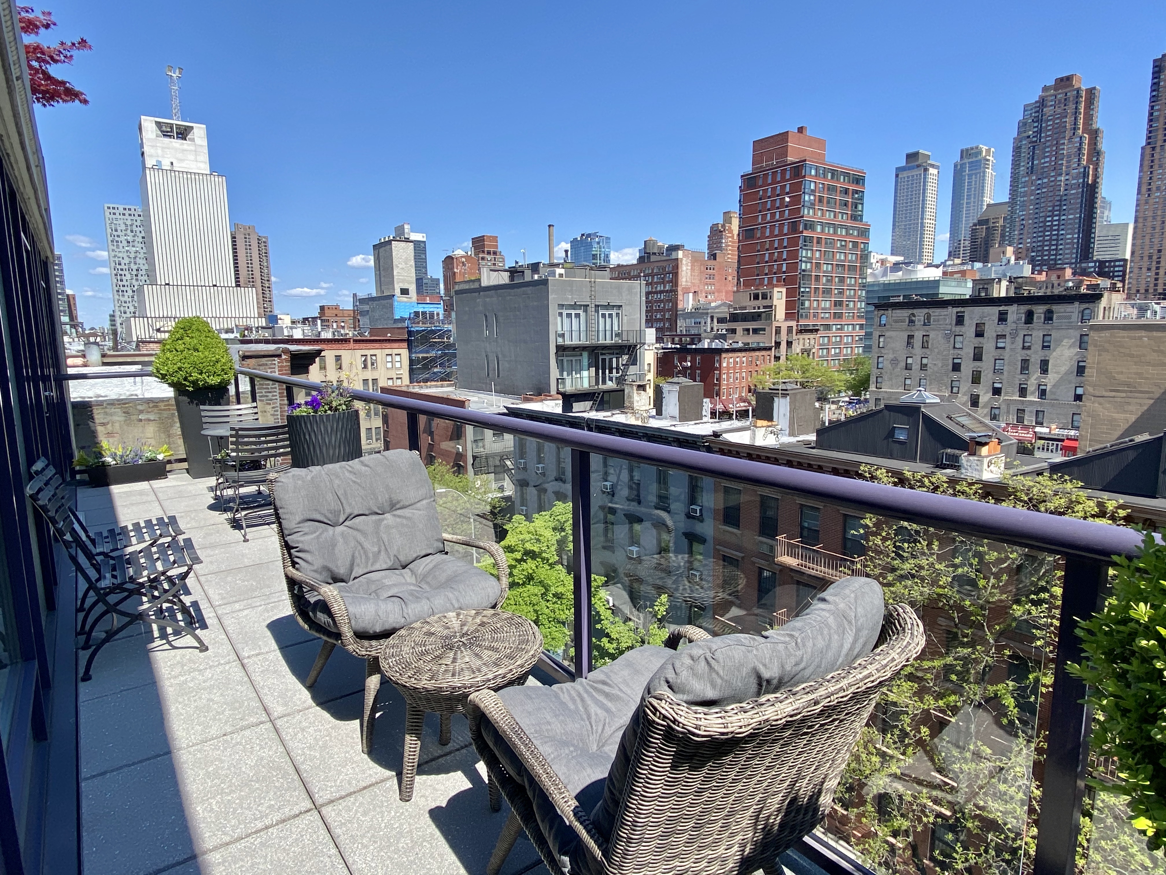 350 West 53rd Street, Unit PHB Manhattan, NY 10019 - Photo 7 of 34 a view of a balcony with two chairs and a potted plant