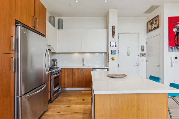 a kitchen with stainless steel appliances a refrigerator and a stove