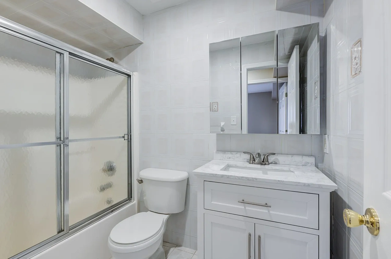 2817 Batchelder Street, Unit 1 Brooklyn, NY 11235 - Photo 4 of 4 a bathroom with a sink toilet vanity and shower