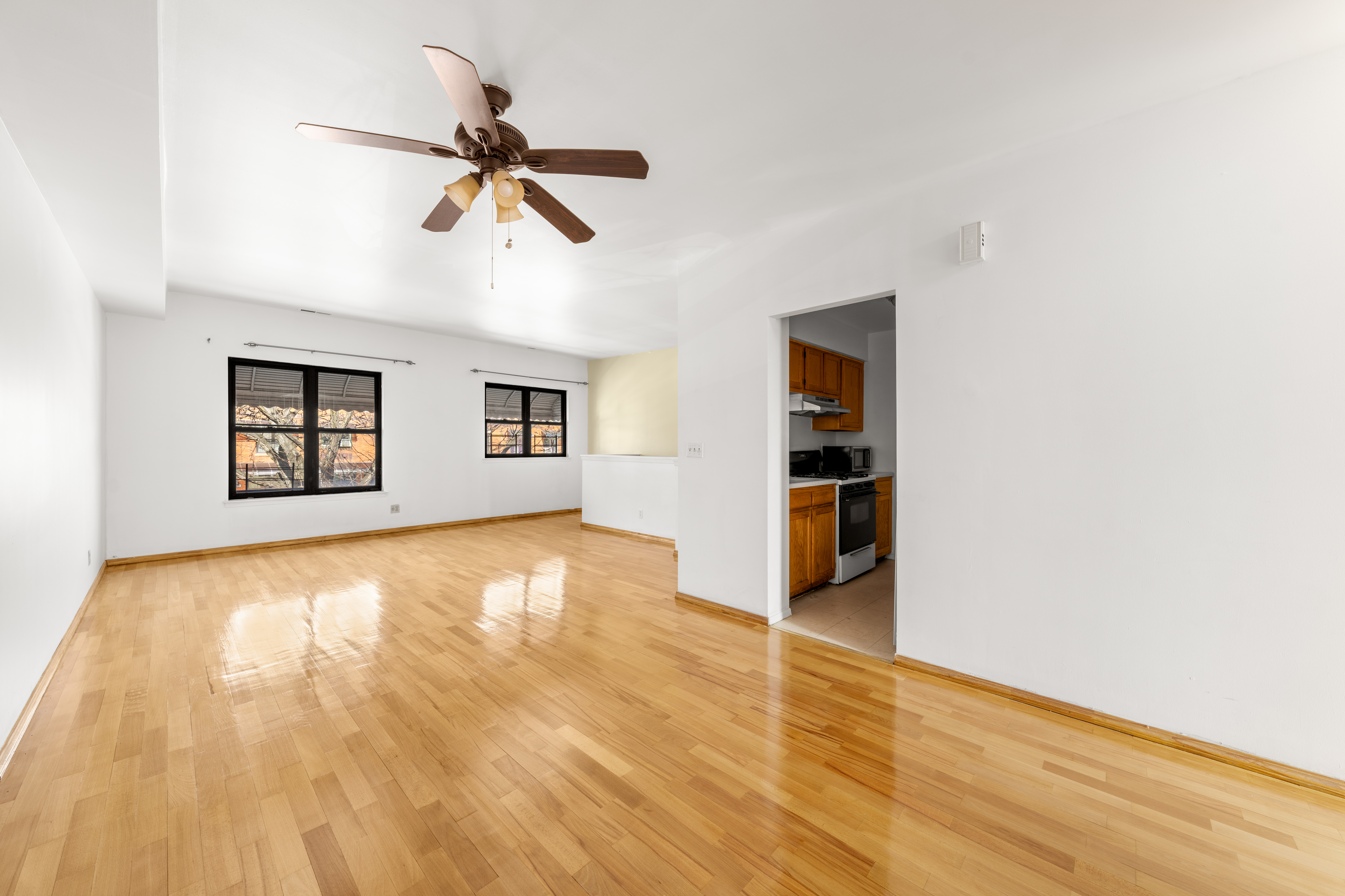1050 Dekalb Avenue, Unit 2 Brooklyn, NY 11221 - Photo 3 of 10 a view of empty room with wooden floor and ceiling fan