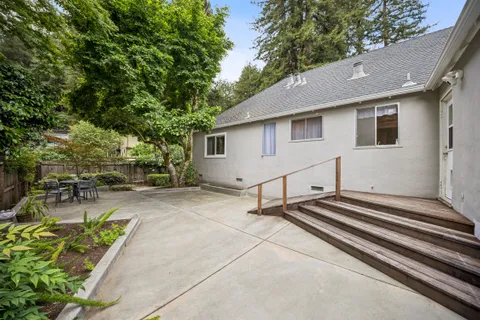 a backyard of a house with table and chairs