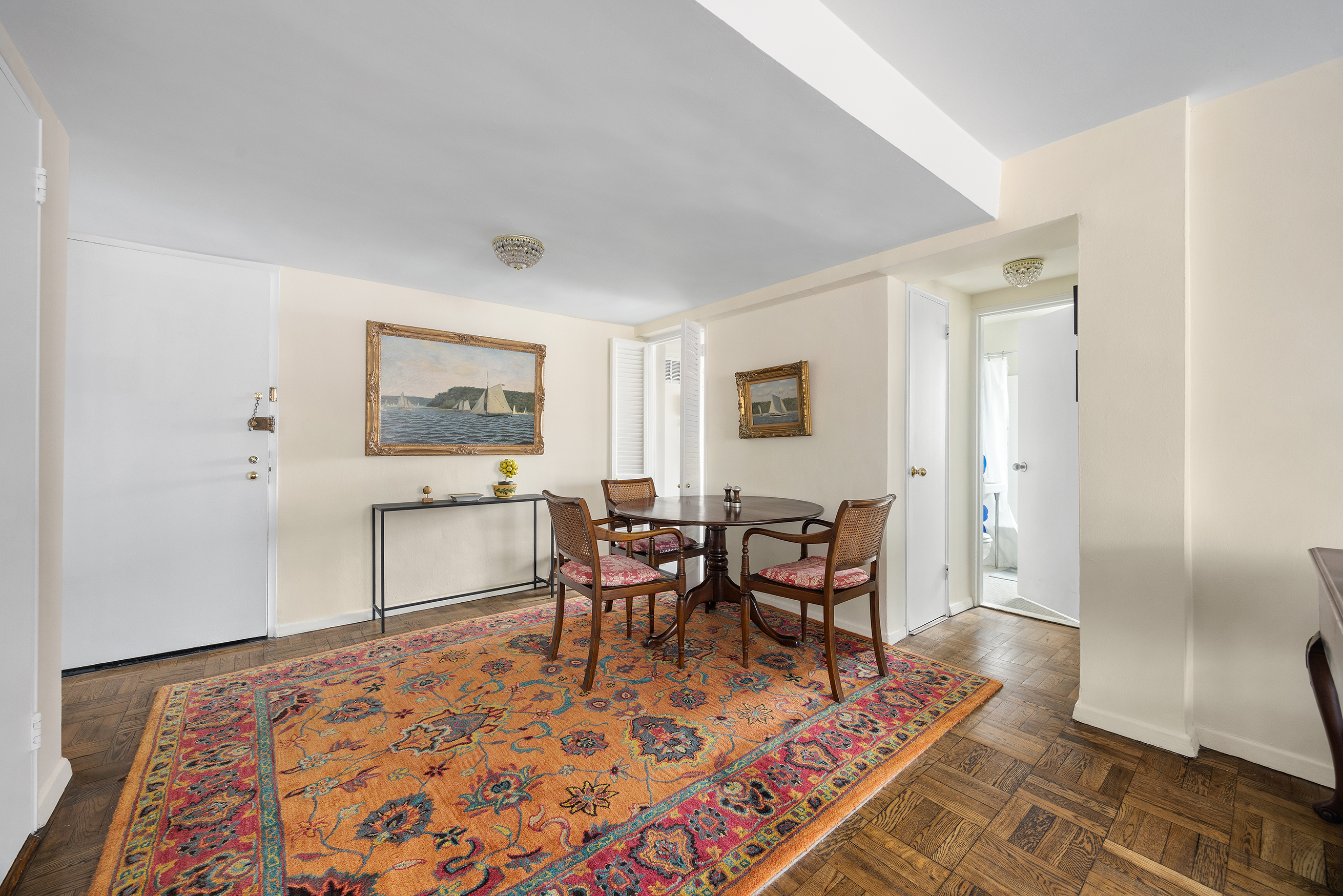 205 East 77th Street, Unit 11B Manhattan, NY 10075 - Photo 6 of 11 a living room with furniture and a rug