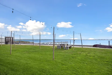 a front view of a house with a yard table and chairs