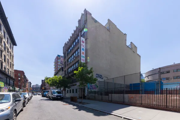 a city street with tall buildings and cars