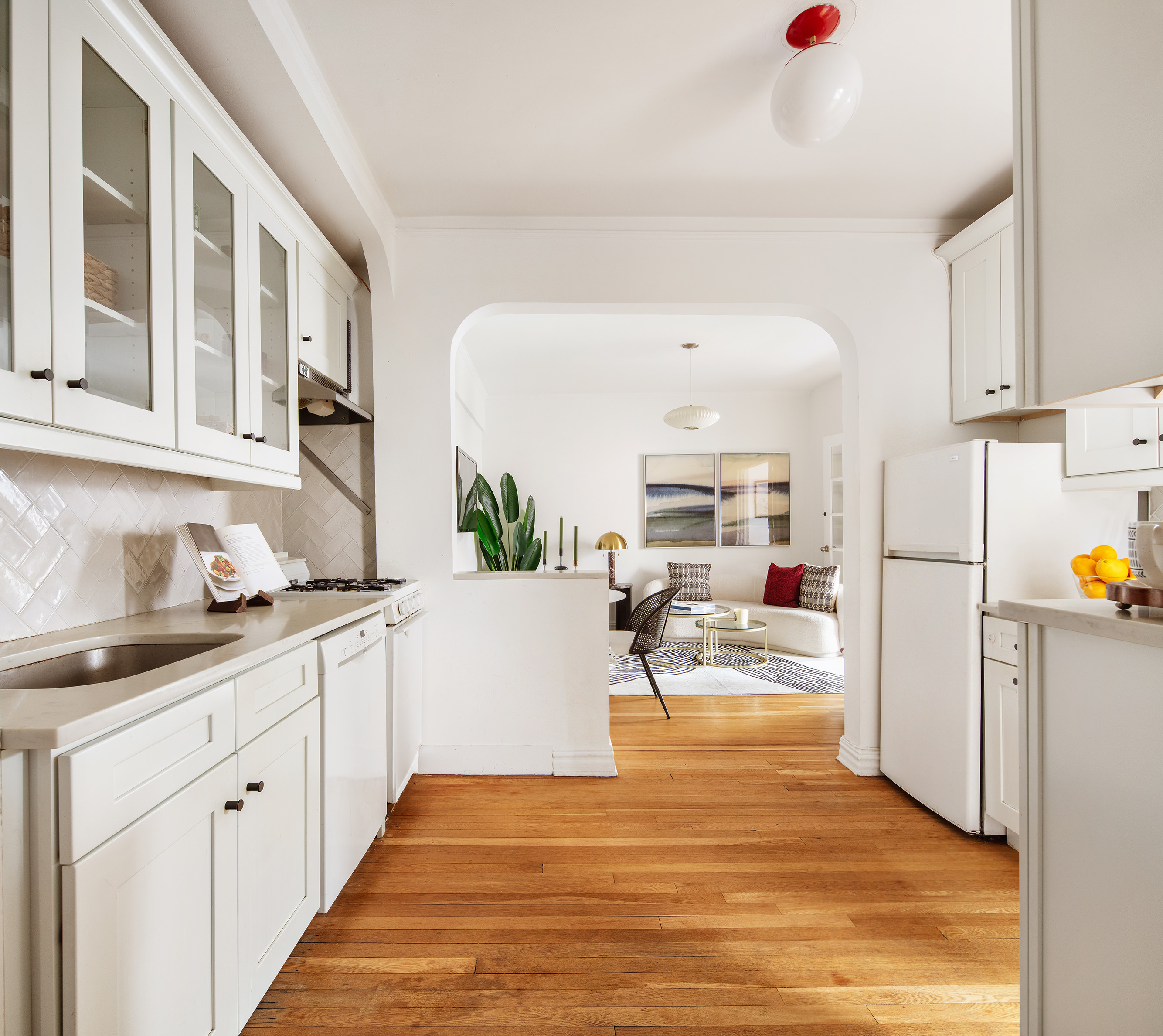 140 East 2nd Street, Unit 5F Brooklyn, NY 11218 - Photo 6 of 9 a living room with stainless steel appliances kitchen island granite countertop a refrigerator and a sink