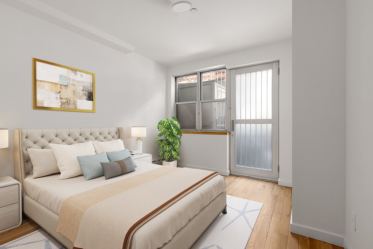 239 East 7th Street, Unit 1 Manhattan, NY 10009 - Photo 4 of 9 a bedroom with a bed and a window