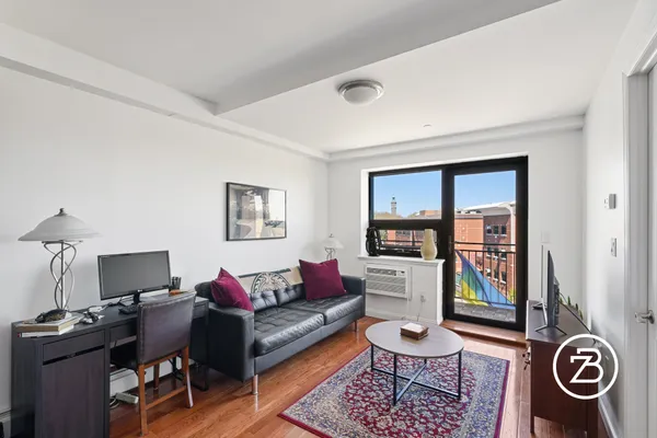 a living room with furniture a rug and a window