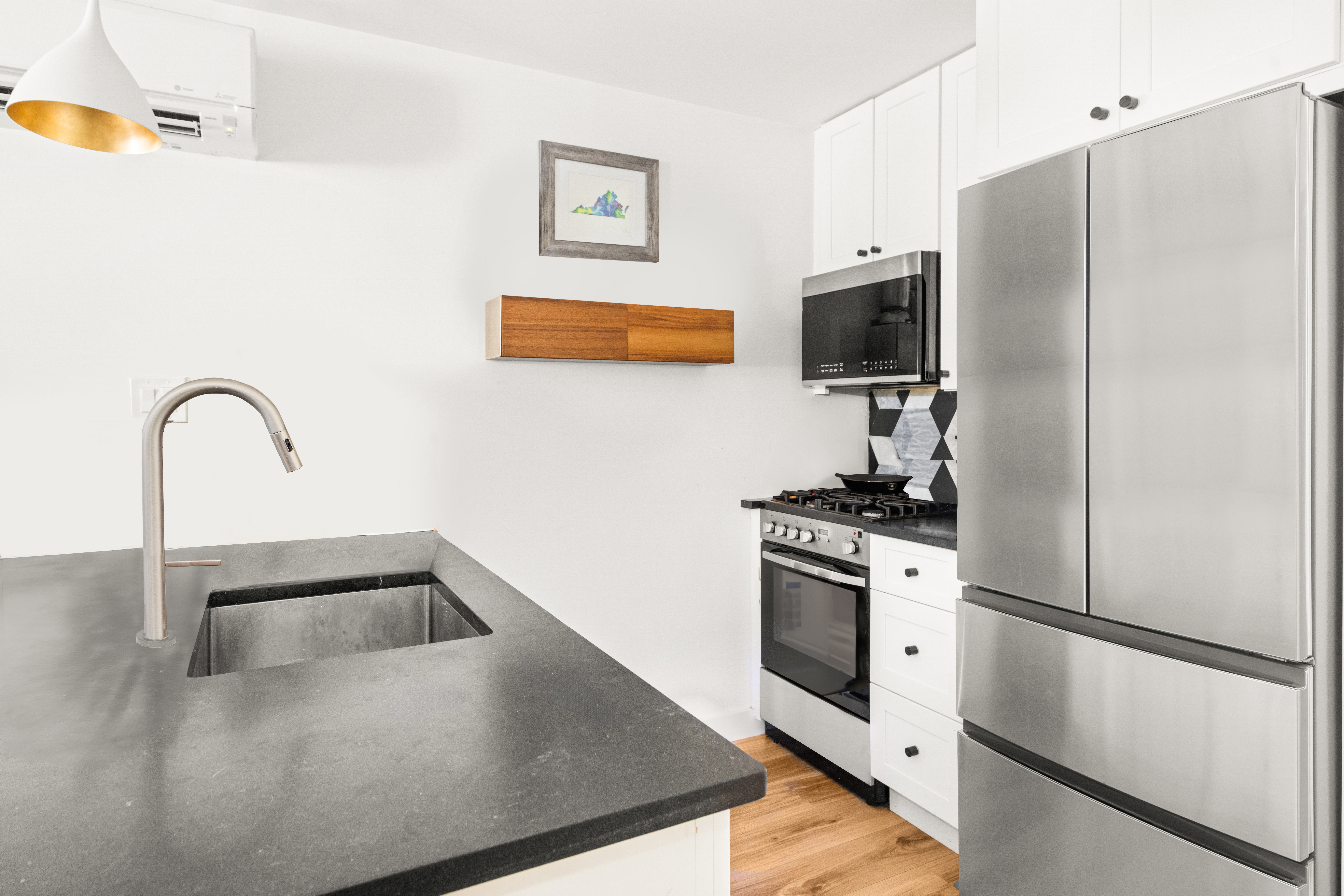 211 14th Street Brooklyn, NY 11215 - Photo 15 of 18 a kitchen with stainless steel appliances granite countertop a refrigerator a stove a sink and a microwave