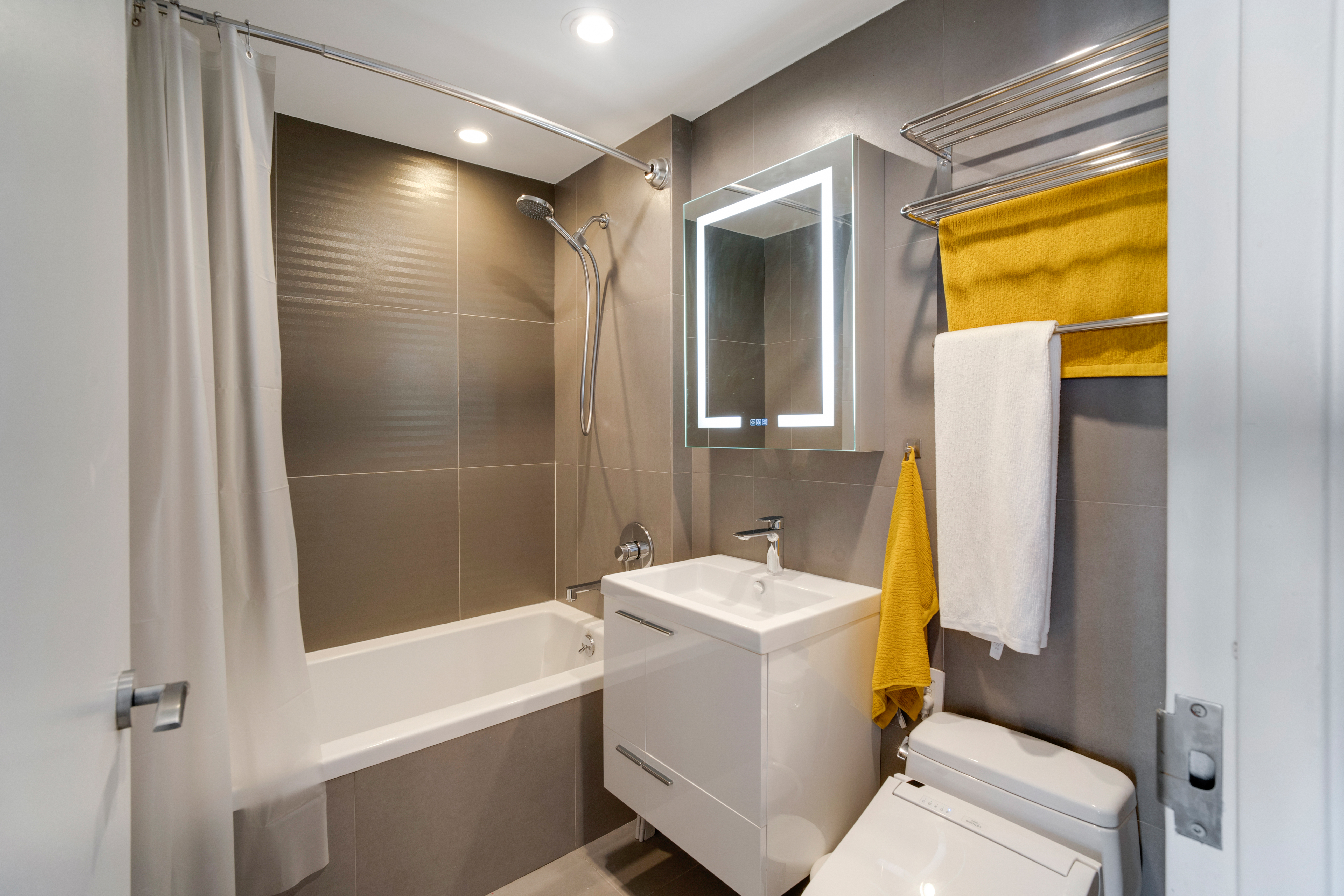 60 Orchard Street, Unit 4 Manhattan, NY 10002 - Photo 15 of 18 a bathroom with a sink toilet and shower